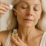 Woman over 40 applying a facial serum as part of her morning mature skin skincare routine